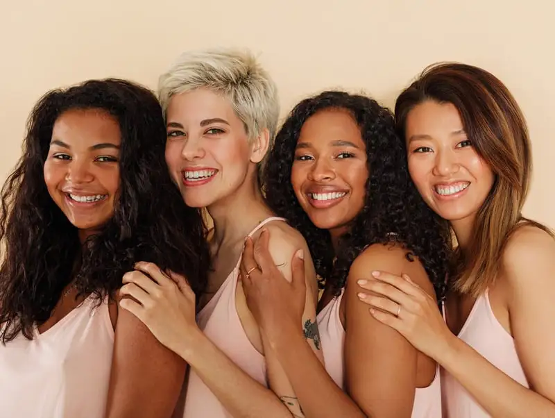 The image features women with diverse, radiant skin tones, ranging from deep to fair, each glowing with natural beauty, emphasizing inclusivity and confidence.